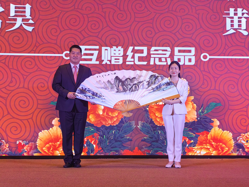 陽朔縣人民政府縣長黃小雪向常昊贈送福利畫扇。